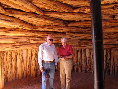 Peter and Ann in a very intricate hogan made of interwoven logs